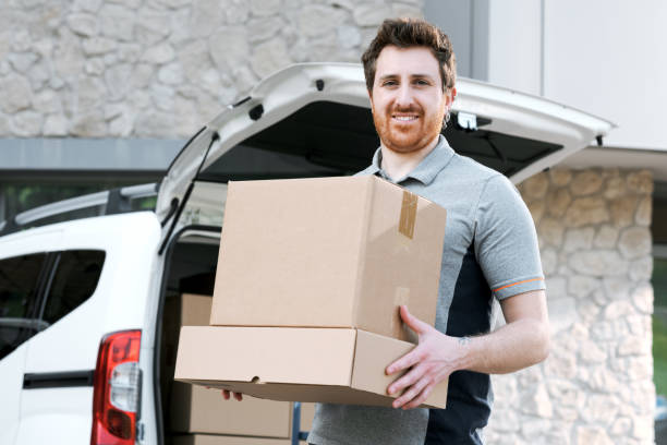 istock Portrait of a delivery guy carrying boxes 2188013317