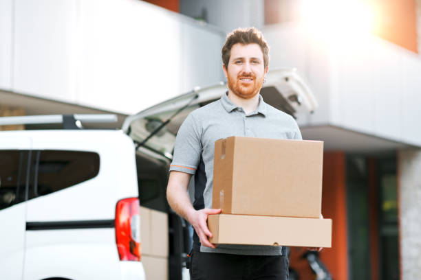 istock Portrait of a delivery man carrying boxes 2188013443