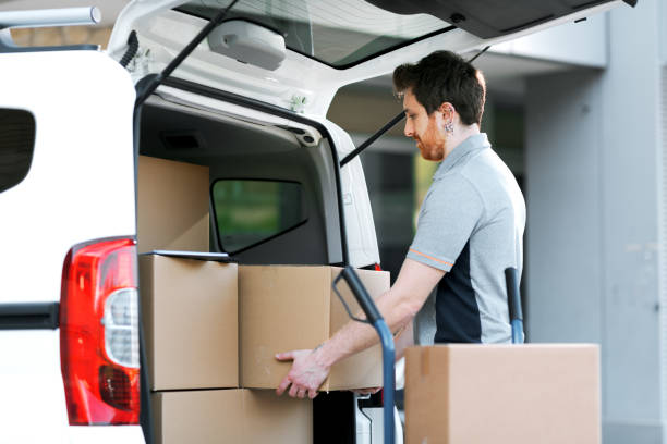 istock Professional delivery man loading packages on a hand truck 2188013556