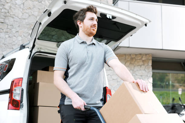 istock Employee moving delivery boxes using a hand truck 2188013618