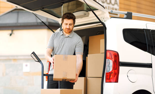 istock Professional delivery man loading packages on a hand truck 2188013695