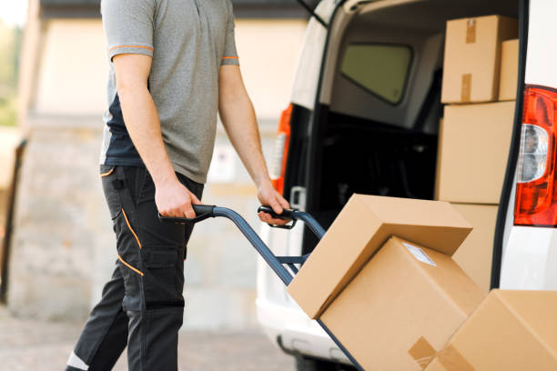 istock Delivery guy pushing a hand truck 2188013803