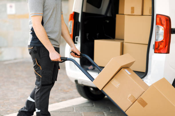 istock Delivery guy pushing a hand truck 2188013862