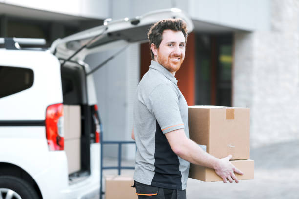 istock Portrait of a delivery man carrying boxes 2188013876