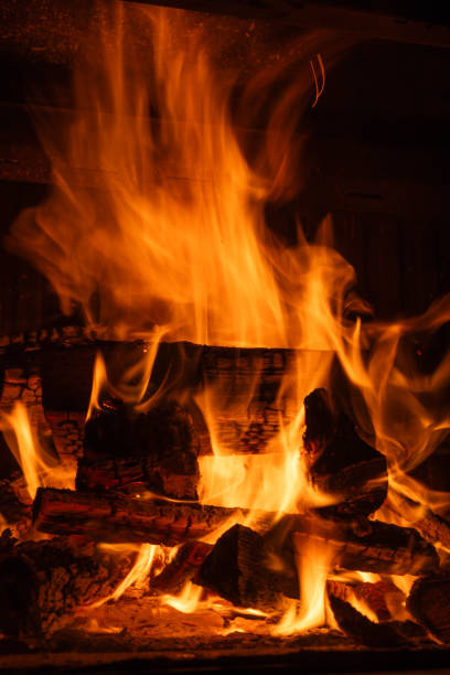 istock Bright flames and glowing embers consuming stacked firewood in a fireplace, long exposure shot 2188013928