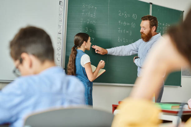 istock Engaging classroom interaction between teacher and students in a lively school environment 2188014158