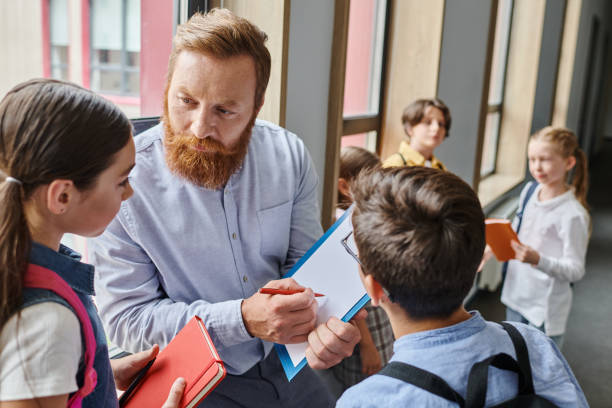 istock Engaging teacher interacts with enthusiastic pupils during a classroom activity at school 2188015507