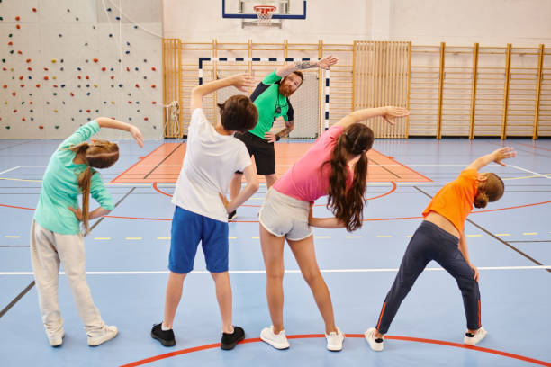 istock Engaging physical activity in a vibrant school gym with a teacher and enthusiastic pupils 2188016421