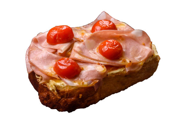 istock Sandwich with brioche, meat, melted cheese, ham, tomatoes, salt, spices and herbs 2188017941