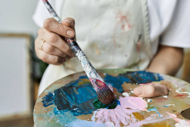 istock Senior woman expressing creativity through painting in her bright studio space 2188018367