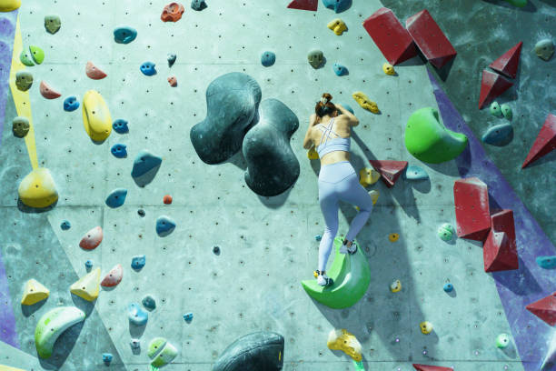 istock Asian sportswoman practices an indoor rock climbing wall. 2188018680