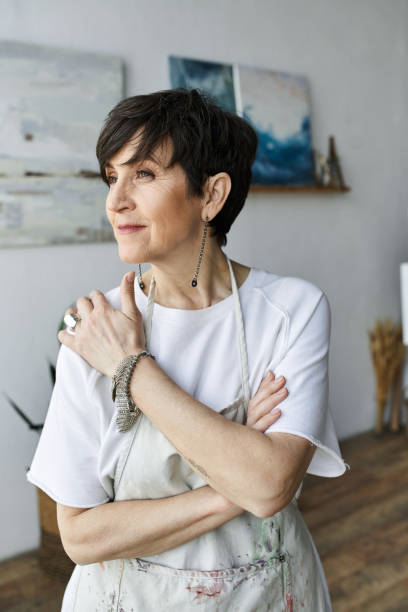 istock Senior woman embraces creativity in her art studio while expressing inspiration 2188019085