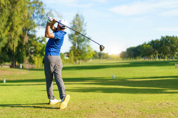 Asian man is playing golf in morning.