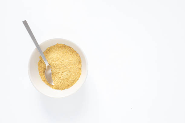 istock Nutritional yeast flakes in the bowl with metal spoon 2188019929