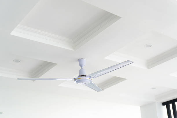istock white ceiling with a white ceiling fan. The ceiling has a decorative trim around the edges. 2188019992