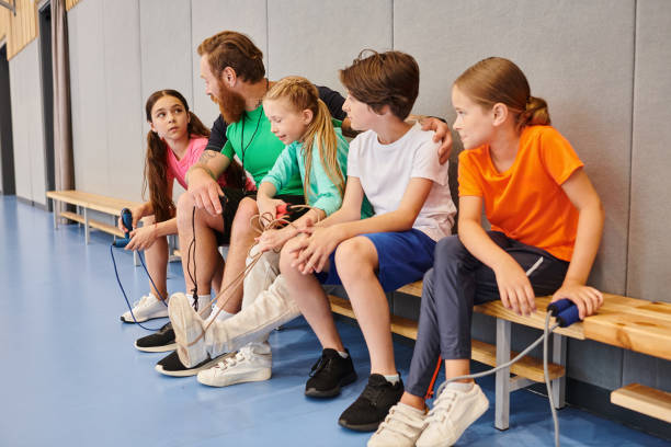 istock Engaging moments between a teacher and students in a lively school activity 2188020135