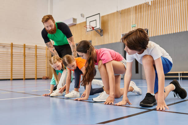istock Excited students prepare for a fun race in physical education class inside a school gymnasium 2188020201