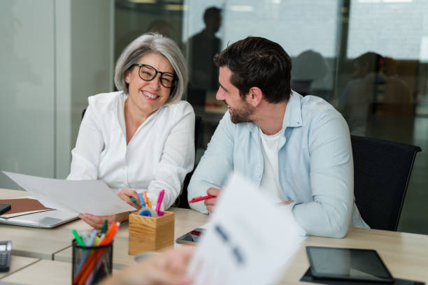 istock colleagues sharing a moment of levity during office meeting 2188022711