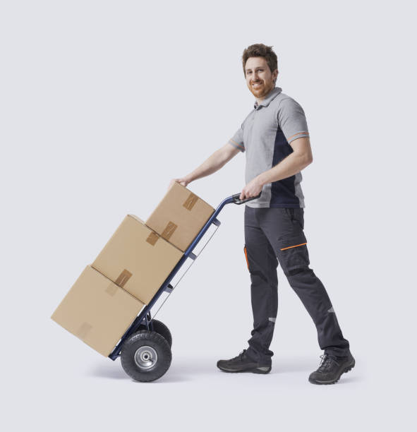 istock Warehouse worker pushing a hand truck 2188023218
