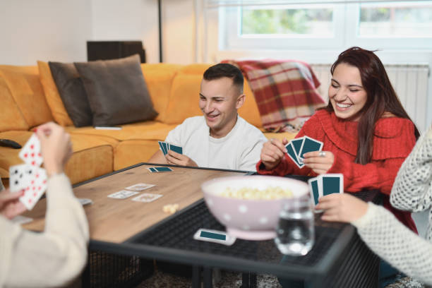 istock Joyful Friend Group Bonding While Playing Card Games on Saturday Night 2188023599