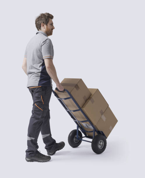istock Warehouse worker moving boxes with a hand truck 2188023847