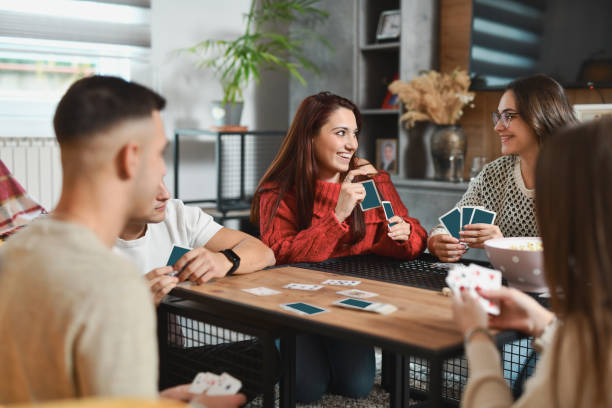 istock Joyful Females Playing Card Game in Pair Smiling Because Winning 2188024375