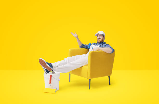 istock House painter sitting and showing the finished work 2188027691
