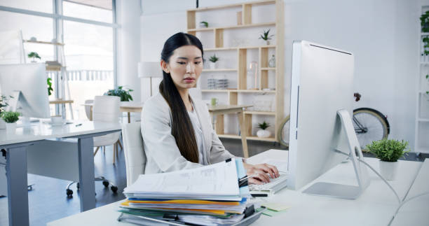 istock Documents, office and business Asian woman on computer for online project, website and overworked. Workload, corporate and person on pc worry with paperwork for research, deadline and administration 2188028050
