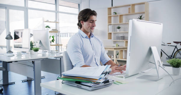 istock Man, computer and typing in office for business, administration and financial planning. Male accountant, tech and documents in agency for feedback, company banking and payment management for audit 2188028079