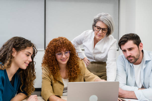istock Business team collaborating on project using laptop in office 2188028901