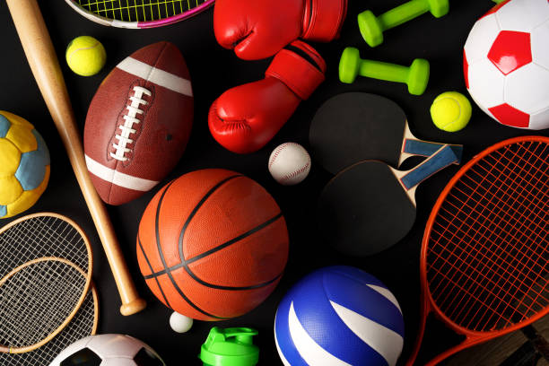 Various sports equipment on black background studio shot close up