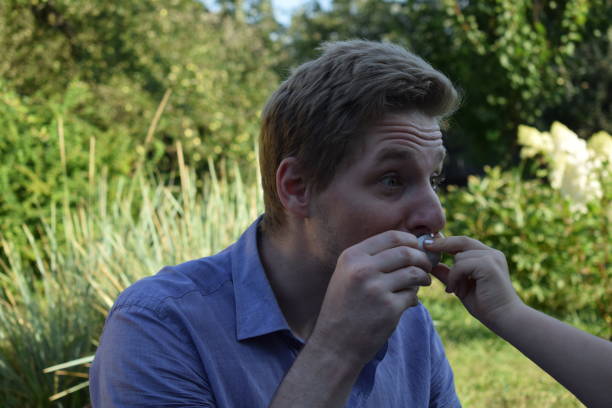 A young father spends quality time with his children outdoors in the backyard, engaging in a playful tea party with stuffed animals. The scene highlights family bonding, imagination, and joy