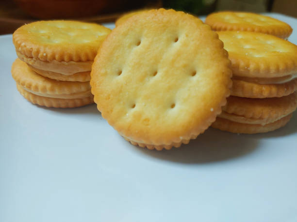 istock Sandwich crackers filled with peanut butter flavored cream in white plate 2188031444