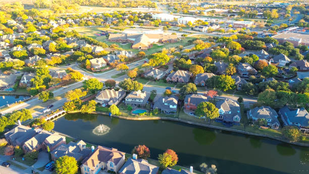 istock Suburban school district in upscale lakeside residential community along MacArthur boulevard in Coppell, suburbs Dallas, Texas, colorful autumn leaves over row of two story large suburban houses 2188031644