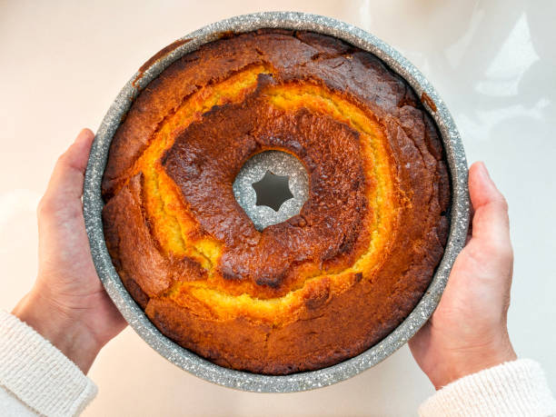 Homemade cake. Directly above a male hands holding homemade sponge cake