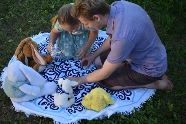 Mother and son relaxing in a park. Mid adult woman about 30 years old and a male child about 2 years old, both Caucasian people.