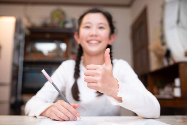 istock A child studying and giving a thumbs up 2188032646