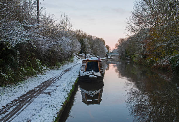 istock Narrowboat moored on a British canal in rural winter setting 2188033266