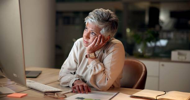 istock Frustrated, mature woman and night with computer for deadline, pressure or difficult task at office. Female person, employee or designer working late with error, mistake or issue for evening report 2188035449