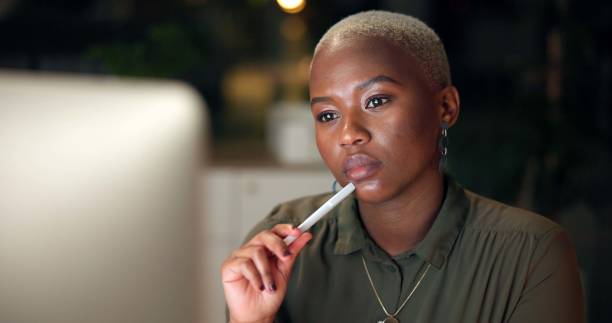 istock Night, black woman and thinking at computer for research, mind map and deadline in office. Journalist, technology and brainstorming in book for article planning, storytelling and reporter in agency 2188035540