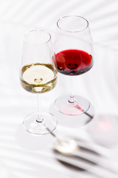 istock Two wine glasses filled with red and white wine 2188037274