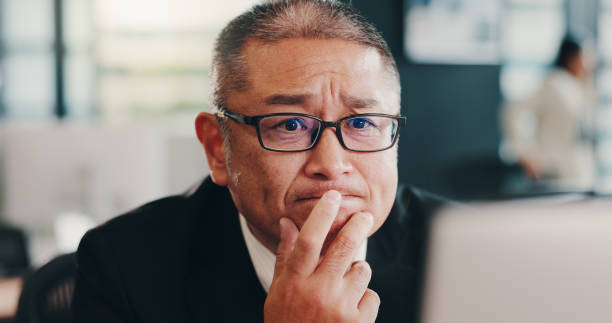 istock Business, thinking and man with computer, decision and online reading with email. Mature person, accounting and employee in workplace, solution or problem solving with choice to review taxes 2188038655