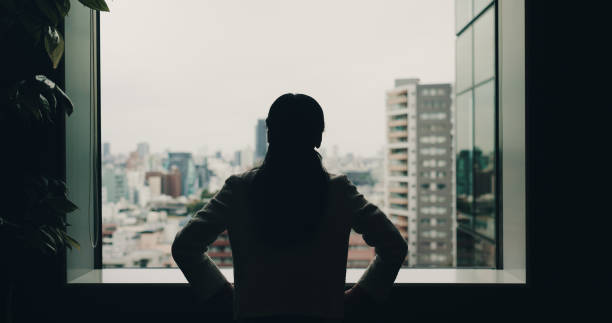 Back, thinking and window with business woman and view for idea, reflection and corporate venture. Vision silhouette and memory with person and city for future, solution and confidence