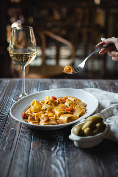Appetizing Italian pasta with cheese on a dark wooden background