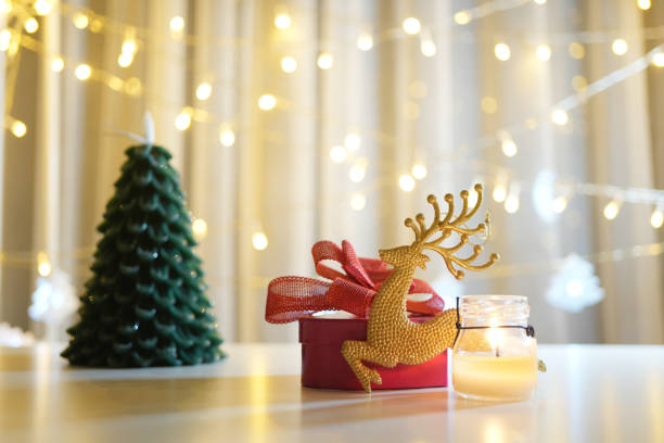 istock gift box with Christmas tree and Christmas scenic decor on table and colorful light bokeh background 2188041969