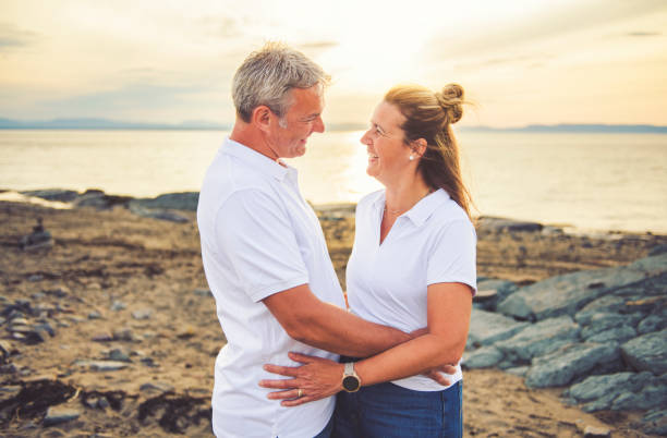istock Happy Romantic Mature Couple Enjoying Sunset on the Beach 2188045946