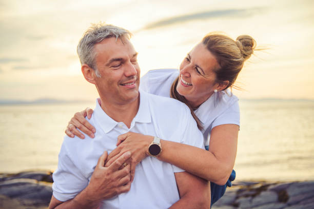 istock Happy Romantic Mature Couple Enjoying Sunset on the Beach 2188046140