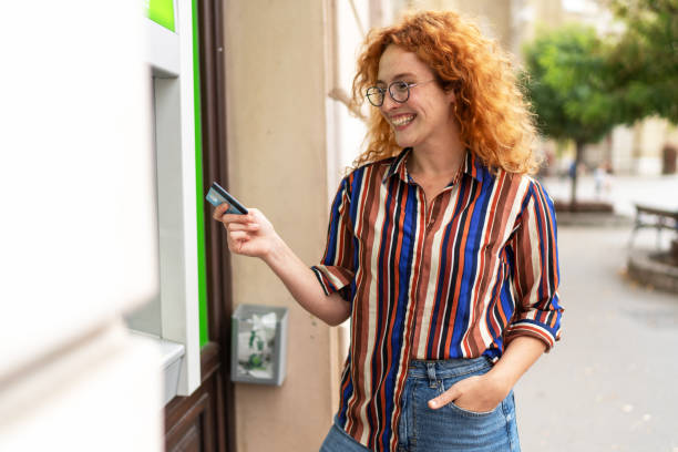 istock Woman withdrawing money from atm 2188048325