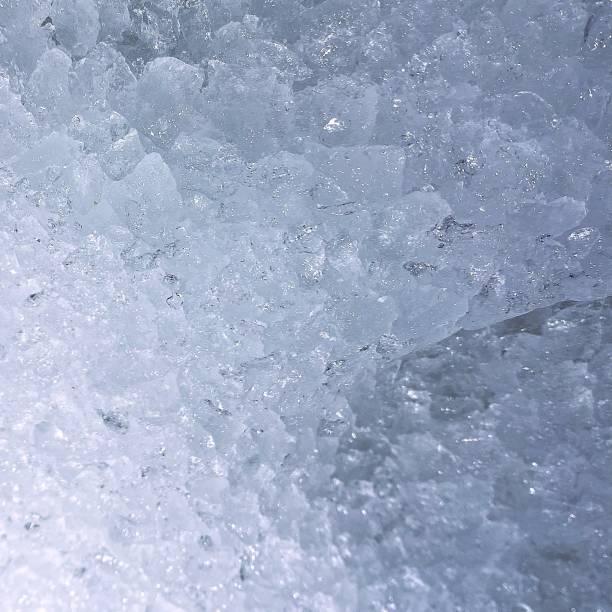 A detailed close-up of ice, showcasing its intricate patterns and textures, capturing the natural beauty of frozen water in stunning detail