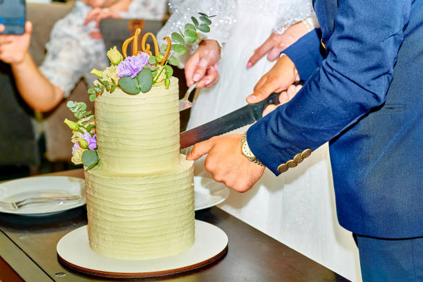 istock Elegant groom in blue suit cutting wedding cake 2188048976